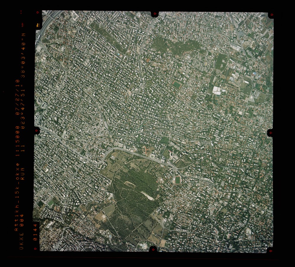 What is the difference between an aerial image and an orthophoto? Example of an aerial image over Attica (source: Ktimatologio S.A. - 2010)